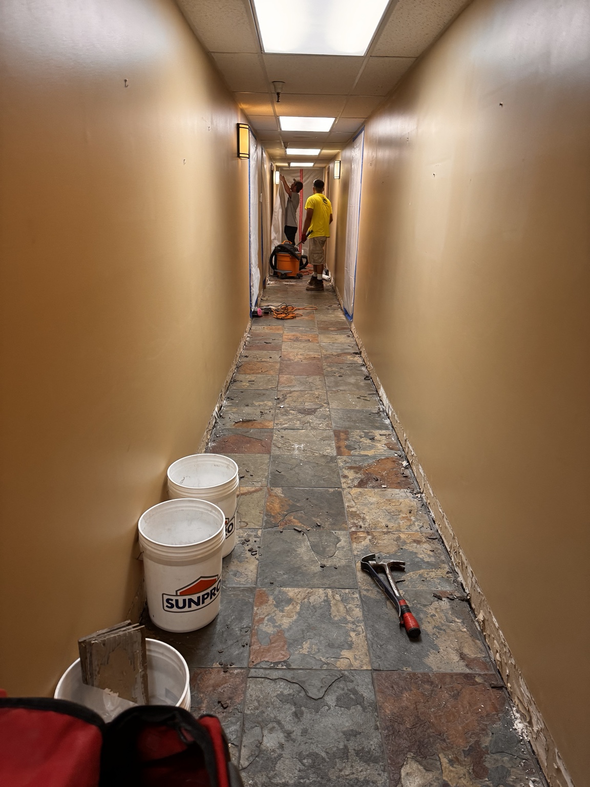 Tiled airport hallway before floor tile removal