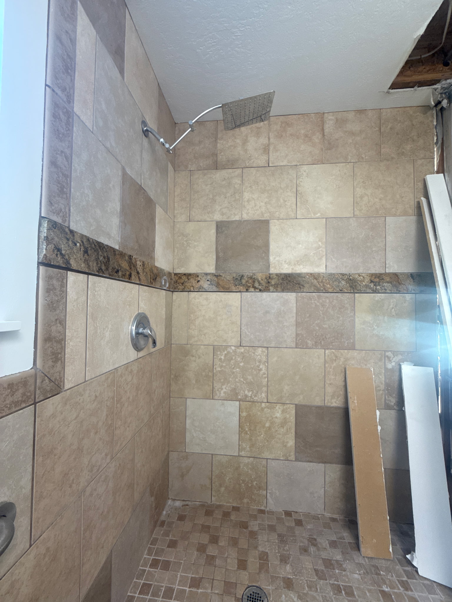 Tiled shower walls and floor before demolition in Orem, Utah